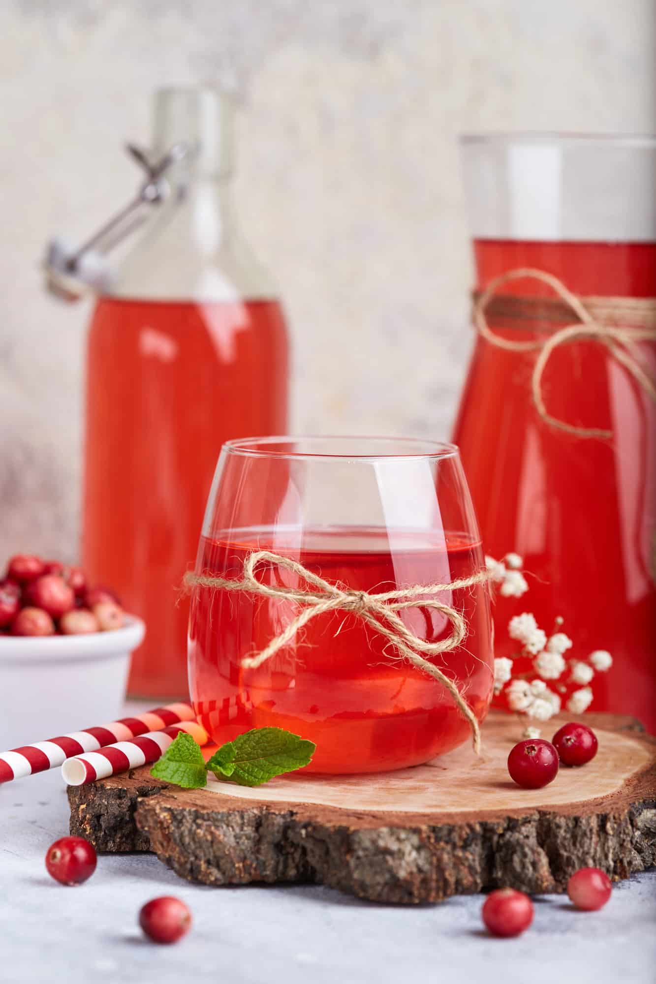 Cranberry mors in a glass on a wooden board.