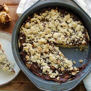 A ma'amoul pie in a pan with a slice taken out.