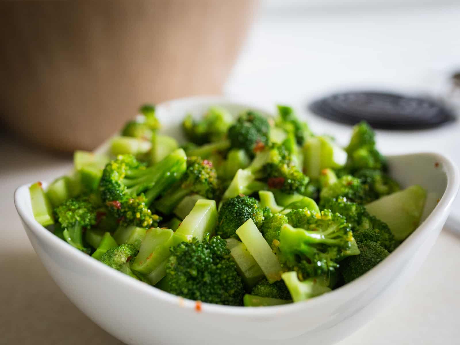 A bowl of broccoli salad in a white bowl.