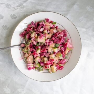 Pickled beet and cucumber salad with a spoon