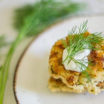 Dill zucchini fritters with dollop of sour cream
