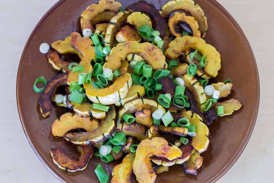 Soft and faintly tropical from the coconut oil, this roasted delicata squash salad melts in your mouth, punctuated by the sharp taste of scallions & seeds.