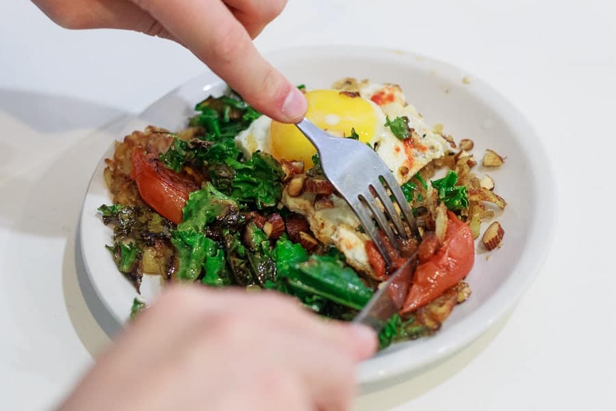 Potato latke topped with egg, kale, tomatoes and Tamari almonds