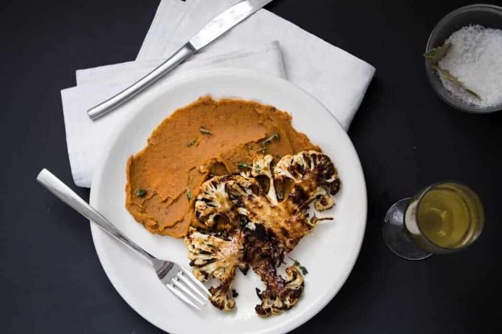 Roasted cauliflower steaks on spicy sweet potato puree