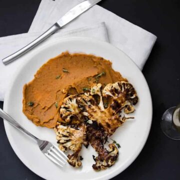 Roasted cauliflower steaks on spicy sweet potato puree