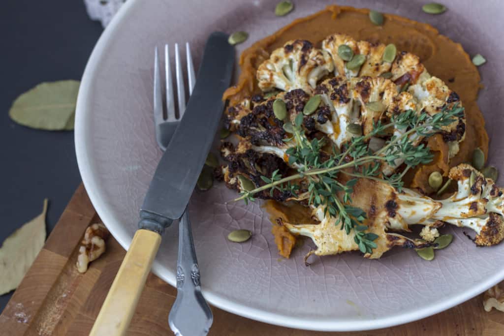 Roasted cauliflower steaks on spicy sweet potato puree