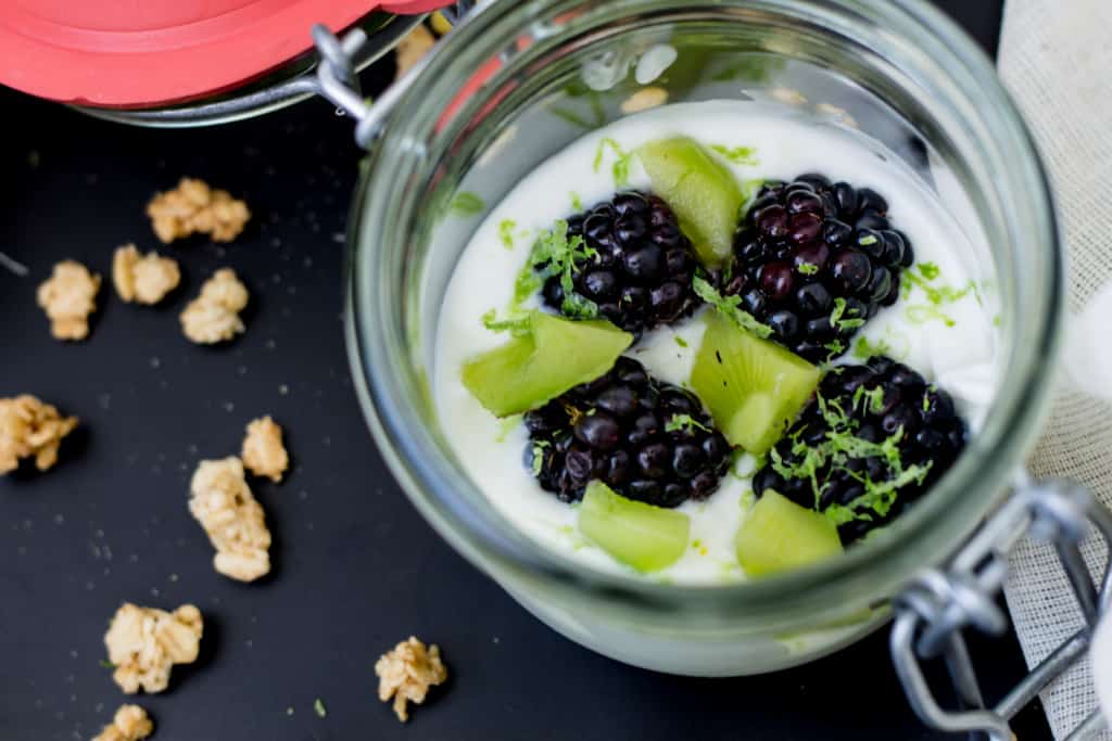 kiwi, lime and blackberry yogurt parfait with granola and pistachios