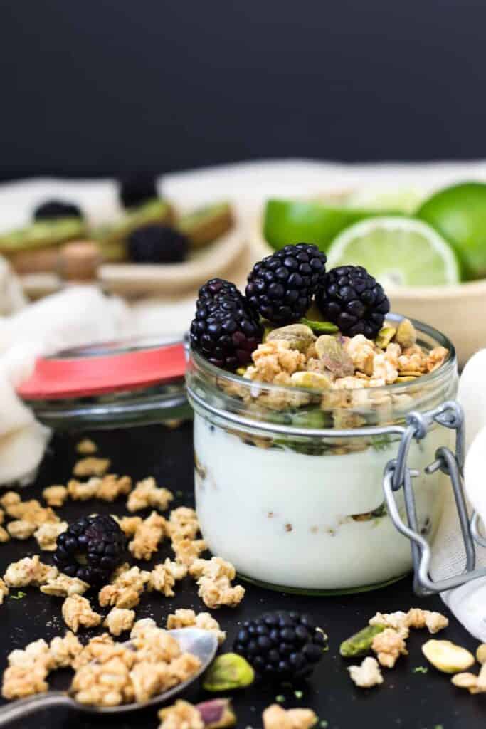 kiwi, lime and blackberry yogurt parfait with granola and pistachios