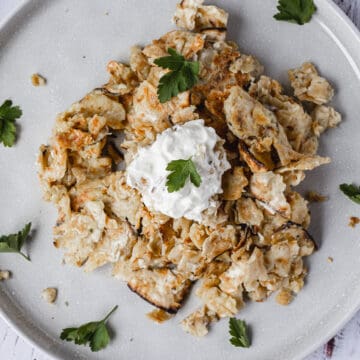 overhead matzo brei with sour cream and parsley