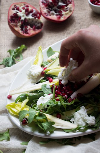 Endive and arugula provide the peppery bite to this arugula salad, while the milky fresh mozzarella brings creaminess, & the pomegranate and pecans the pop.