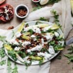 Endive and arugula provide the peppery bite to this arugula salad, while the milky fresh mozzarella brings creaminess, & the pomegranate and pecans the pop.