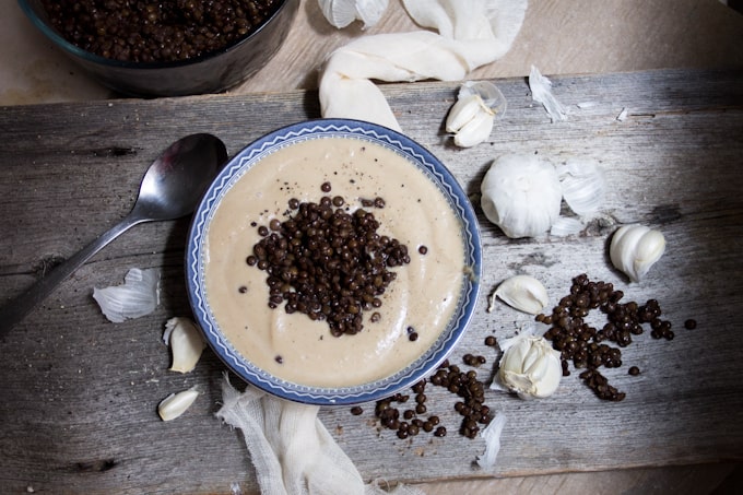 Celery root soup with roasted garlic and lentils is a heady, earthy affair that tastes light & intriguing. It also looks a lot like Thomas Keller's Oysters and Pearls.