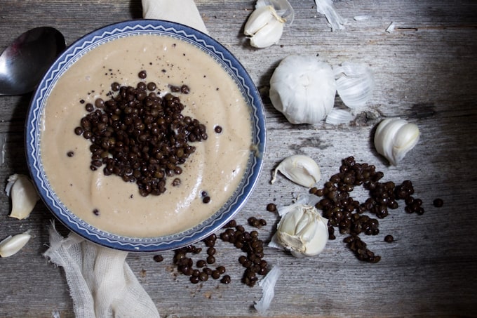 Celery root soup with roasted garlic and lentils is a heady, earthy affair that tastes light & intriguing. It also looks a lot like Thomas Keller's Oysters and Pearls.