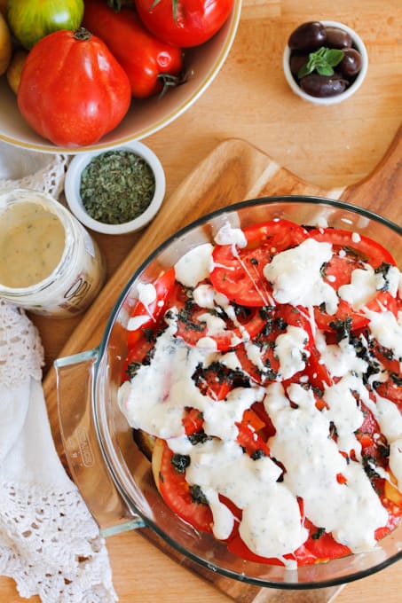 A lightened up version of a classic, this cold moussaka is layered with eggplant, potatoes and tomatoes, and served with tangy kalamata feta sauce.