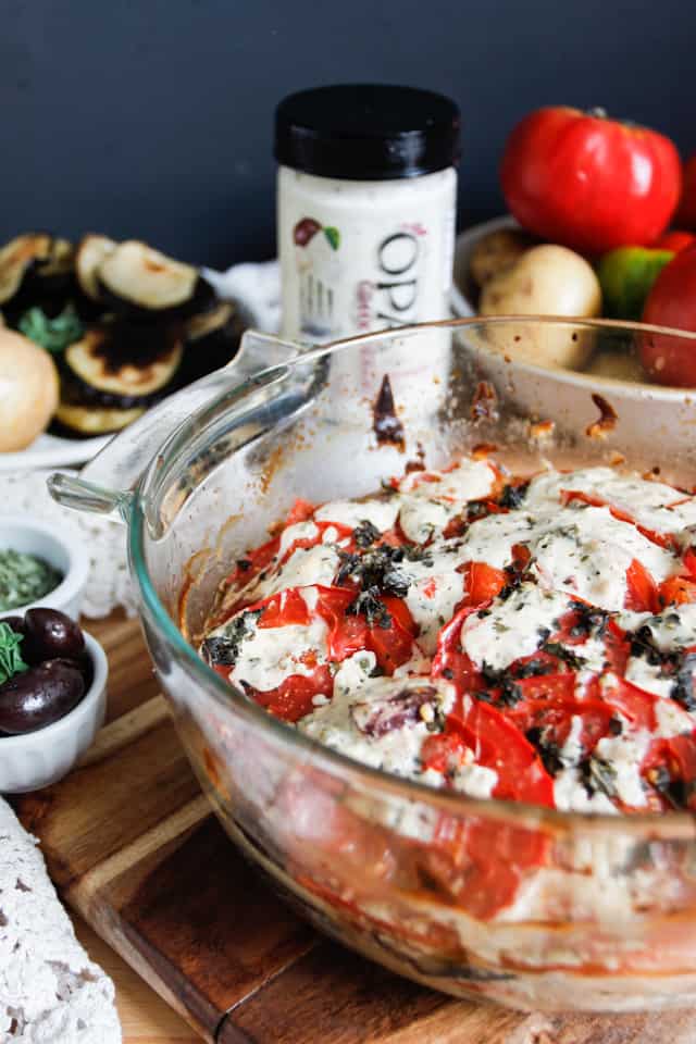 A lightened up version of a classic, this cold moussaka is layered with eggplant, potatoes and tomatoes, and served with tangy kalamata feta sauce.