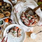 A lightened up version of a classic, this cold moussaka is layered with eggplant, potatoes and tomatoes, and served with tangy kalamata feta sauce.