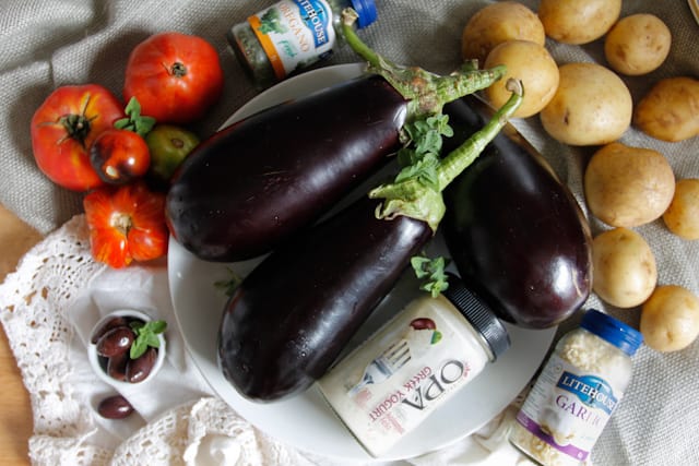 A lightened up version of a classic, this cold moussaka is layered with eggplant, potatoes and tomatoes, and served with tangy kalamata feta sauce.