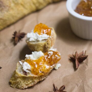 A slice of bread with ground cherry jam on it.