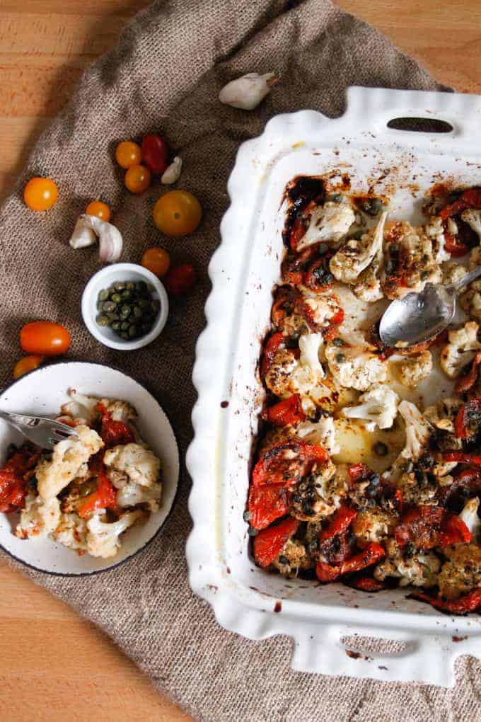 Roasted cauliflower with tomatoes and capers is caramelized, rich in flavour and glistening with sauce, a perfect dish to welcome you home or whip up on a weeknight.