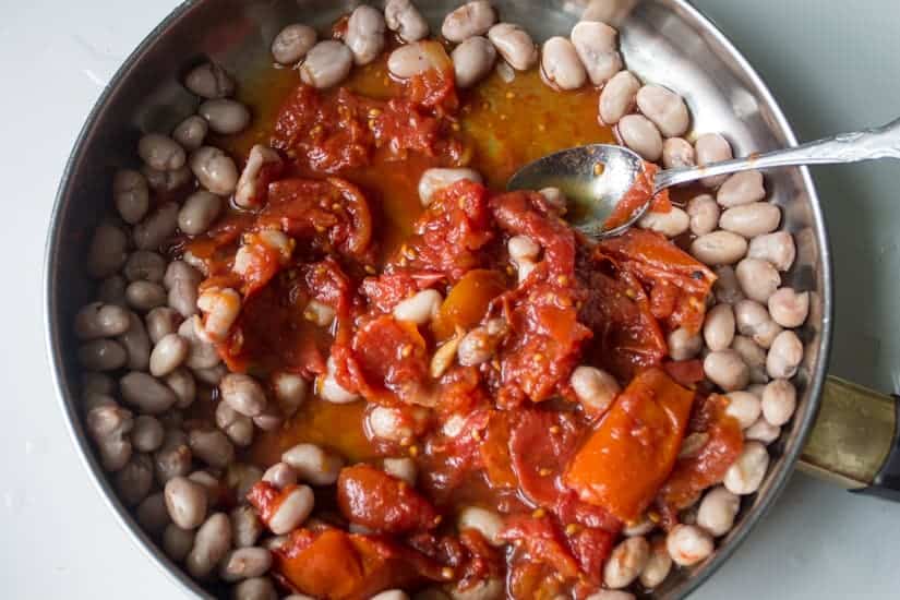 You simply can't stop eating these borlotti beans in tomato sauce with eggs. They're saucy, spicy and so meaty!