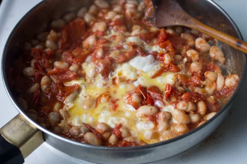 You simply can't stop eating these borlotti beans in tomato sauce with eggs. They're saucy, spicy and so meaty!