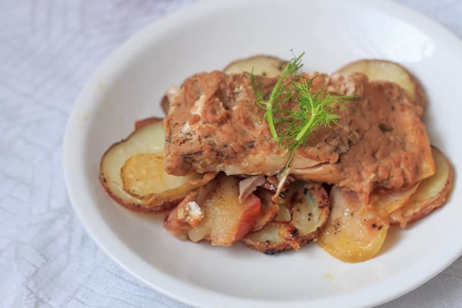 Dressed in spiced apple sauce and cooked to perfection, this roasted salmon rests on a bed of naturally sweet, caramelized apples and potatoes.