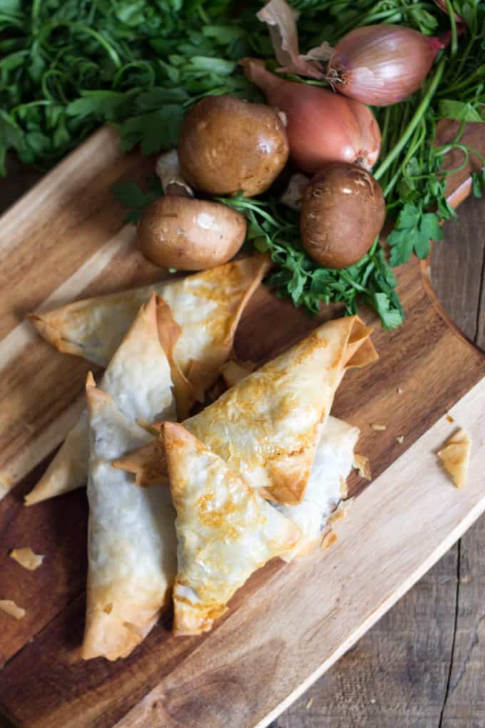 mushroom bourekas on cutting board with mushrooms