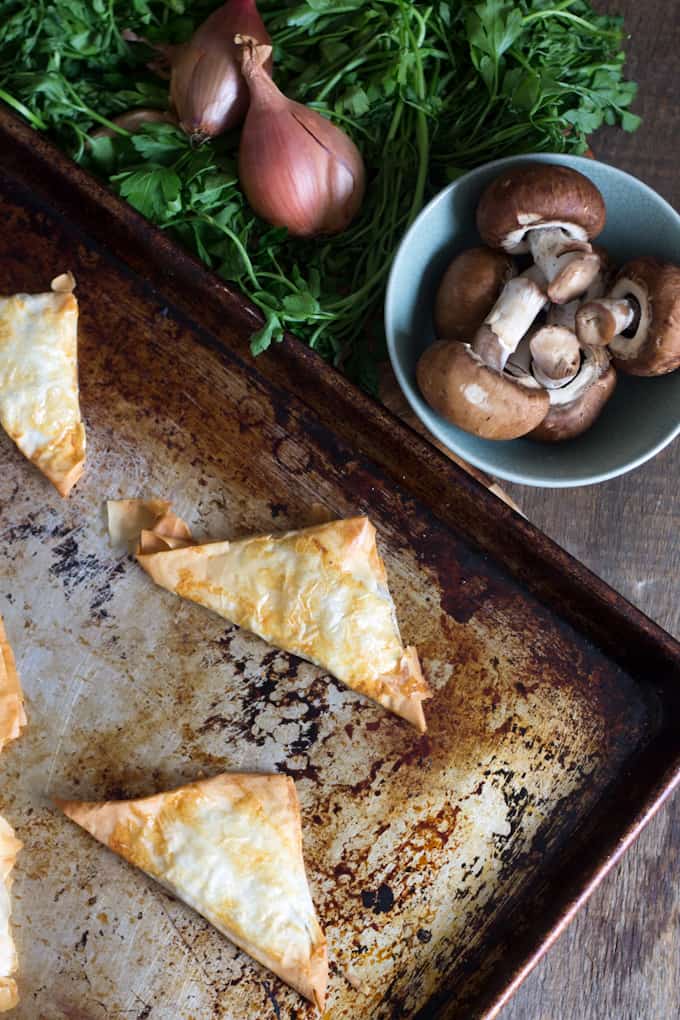 Mushroom bourekas are flaky phyllo dough pockets, filled with a salty, sweet and earthy mixture of mushrooms and caramelized onions.
