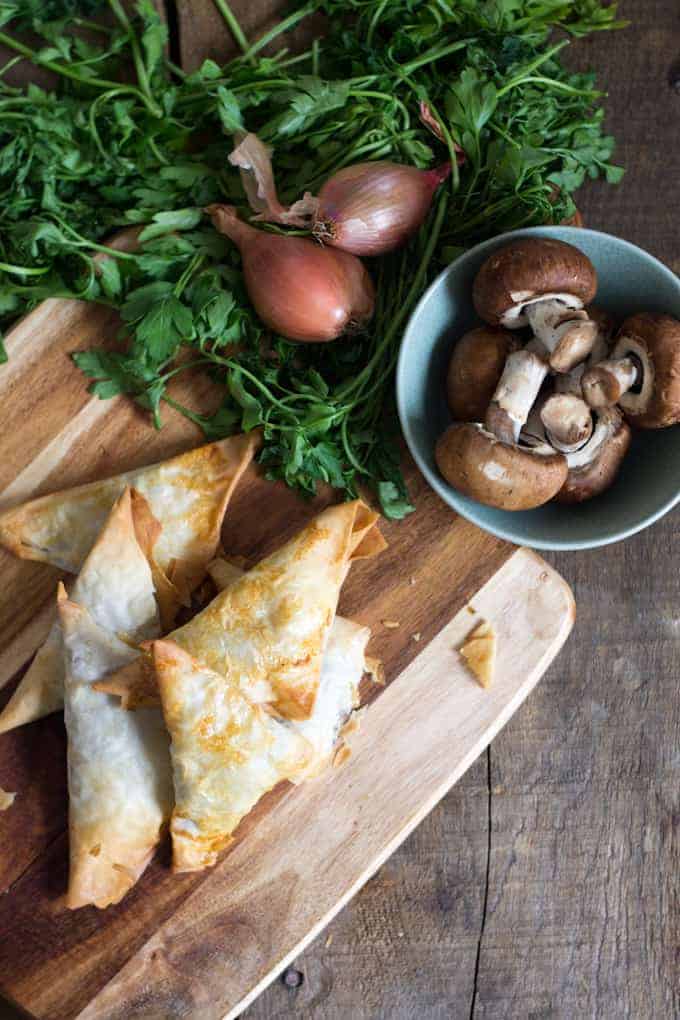 mushroom bourekas on cutting board with mushrooms