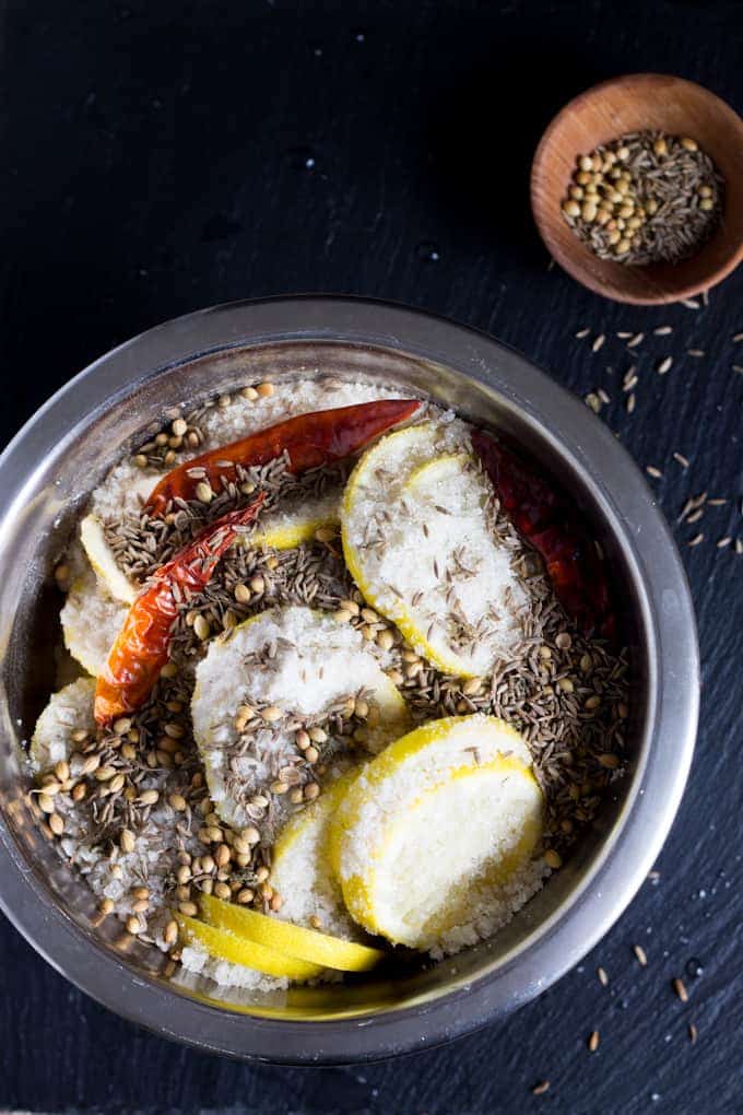 These spiced preserved lemons swim in a heady combination of chunky salt, fiery dried chilies, fragrant whole coriander seeds, and earthy whole cumin seeds.