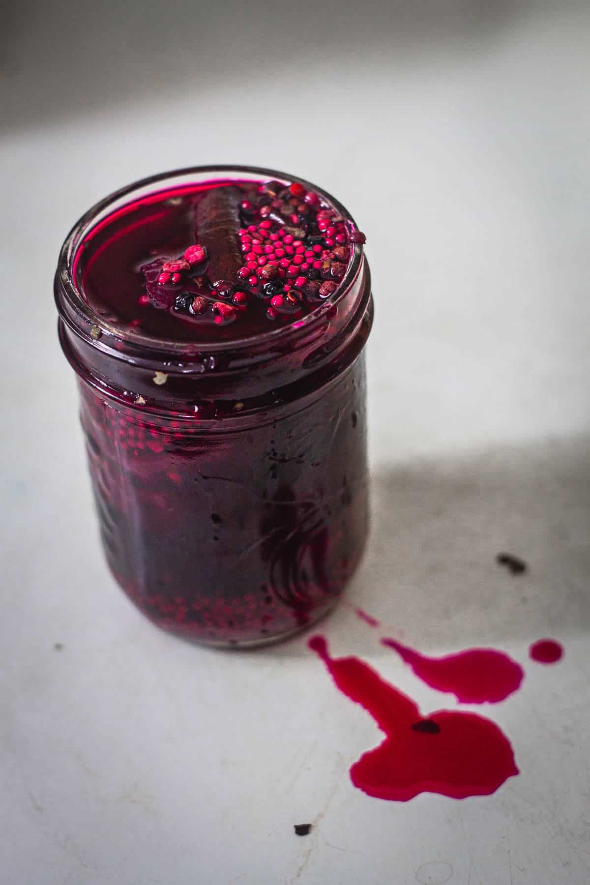 Overhead view of open jar of pickled beets.