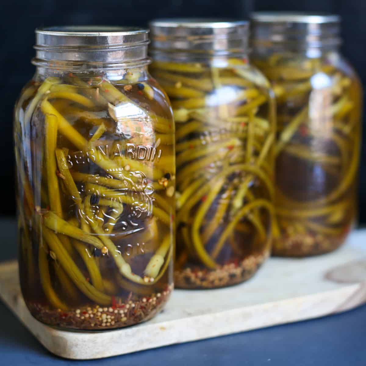 https://immigrantstable.com/wp-content/uploads/2016/08/pickled-garlic-scapes-THUMBNAIL-1.jpg