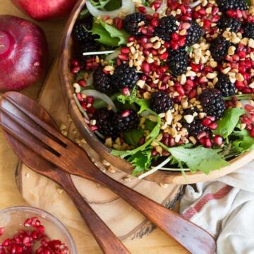 Berry salad with red onions, arugula, nuts and pomegranate arils