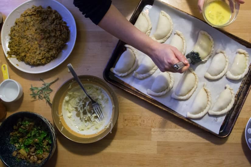 brushing empanadas with egg wash