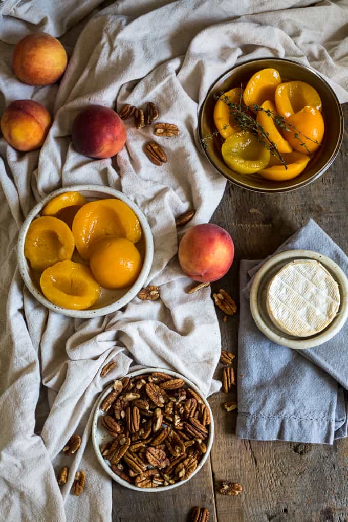 Baked brie with peaches, pecans, herbs and honey