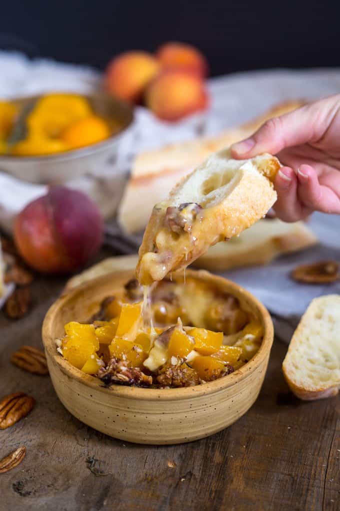 Baked brie with peaches, pecans, herbs and honey