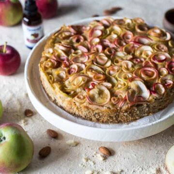 45 degree view of apple almond cake with extract and apples