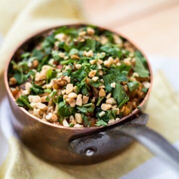 small saucepan with Russian plov sprinkled with herbs