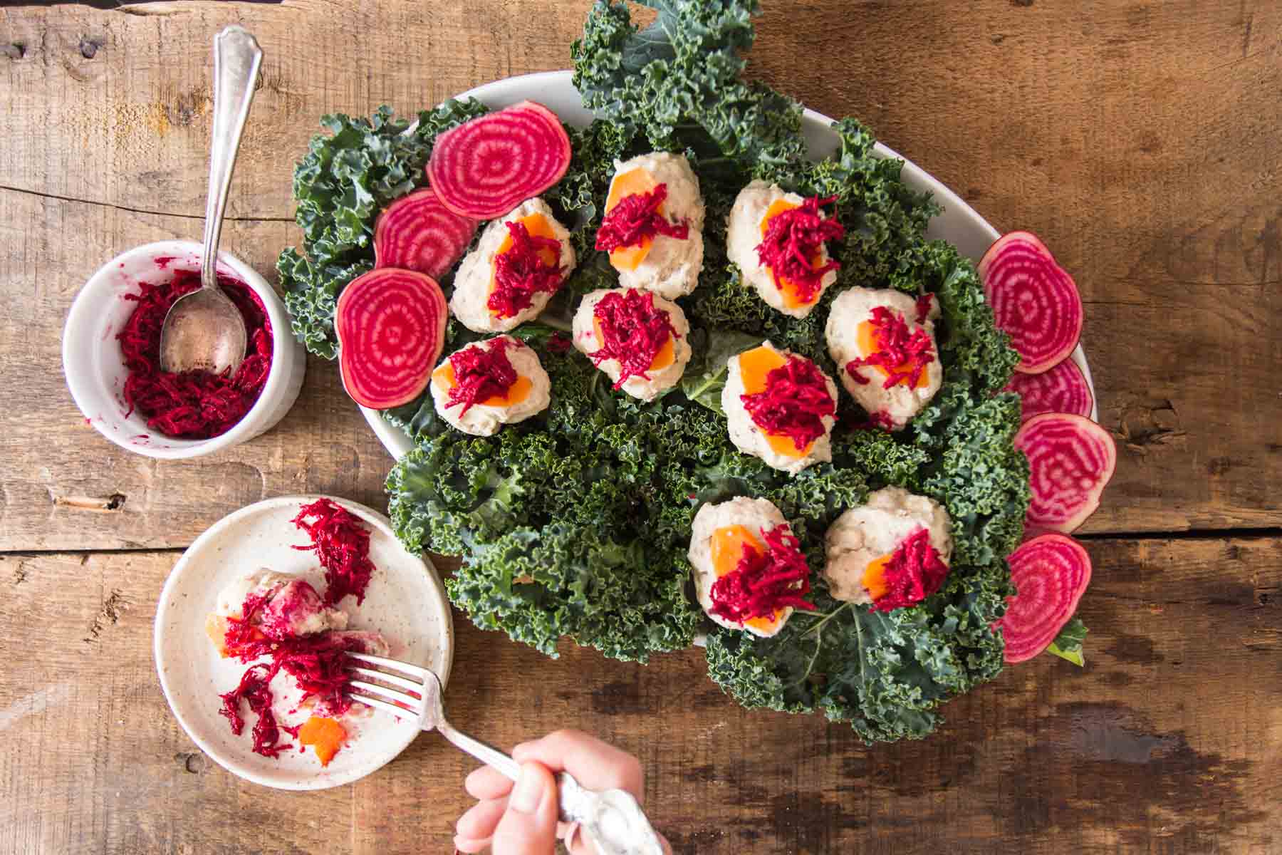 cooked gefilte fish with beetroot horseradish and carrot slices