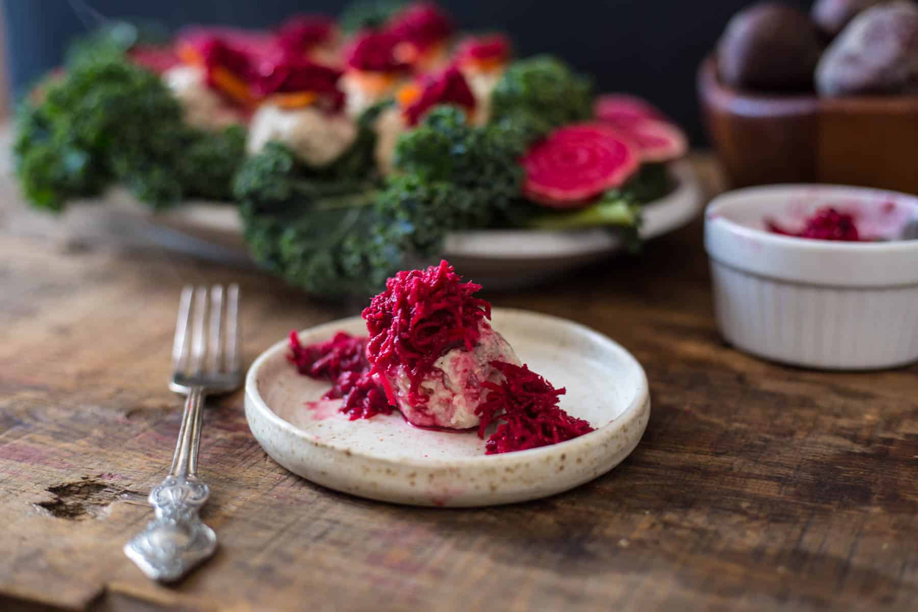 close up on gefilte fish with beetroot on plate