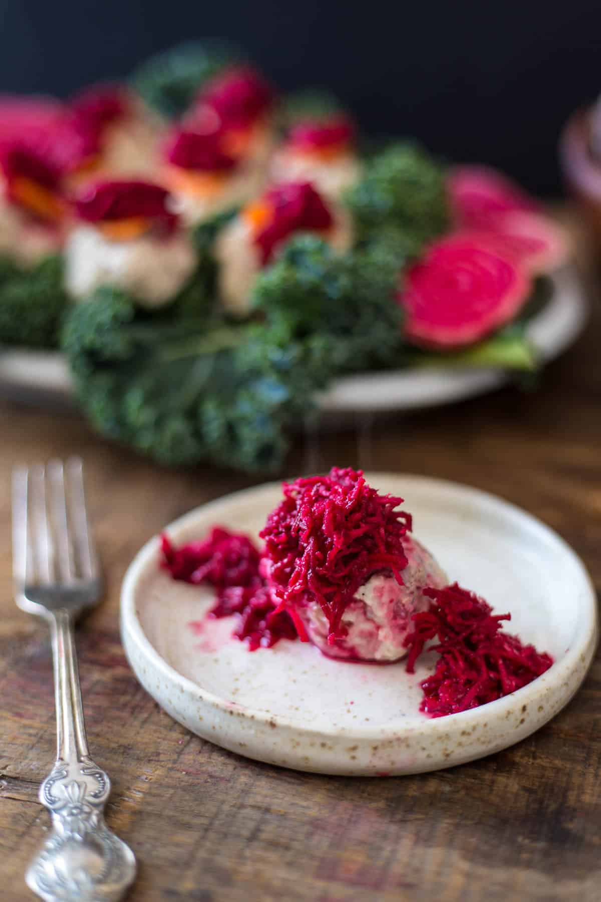 close up on gefilte fish with beetroot on plate