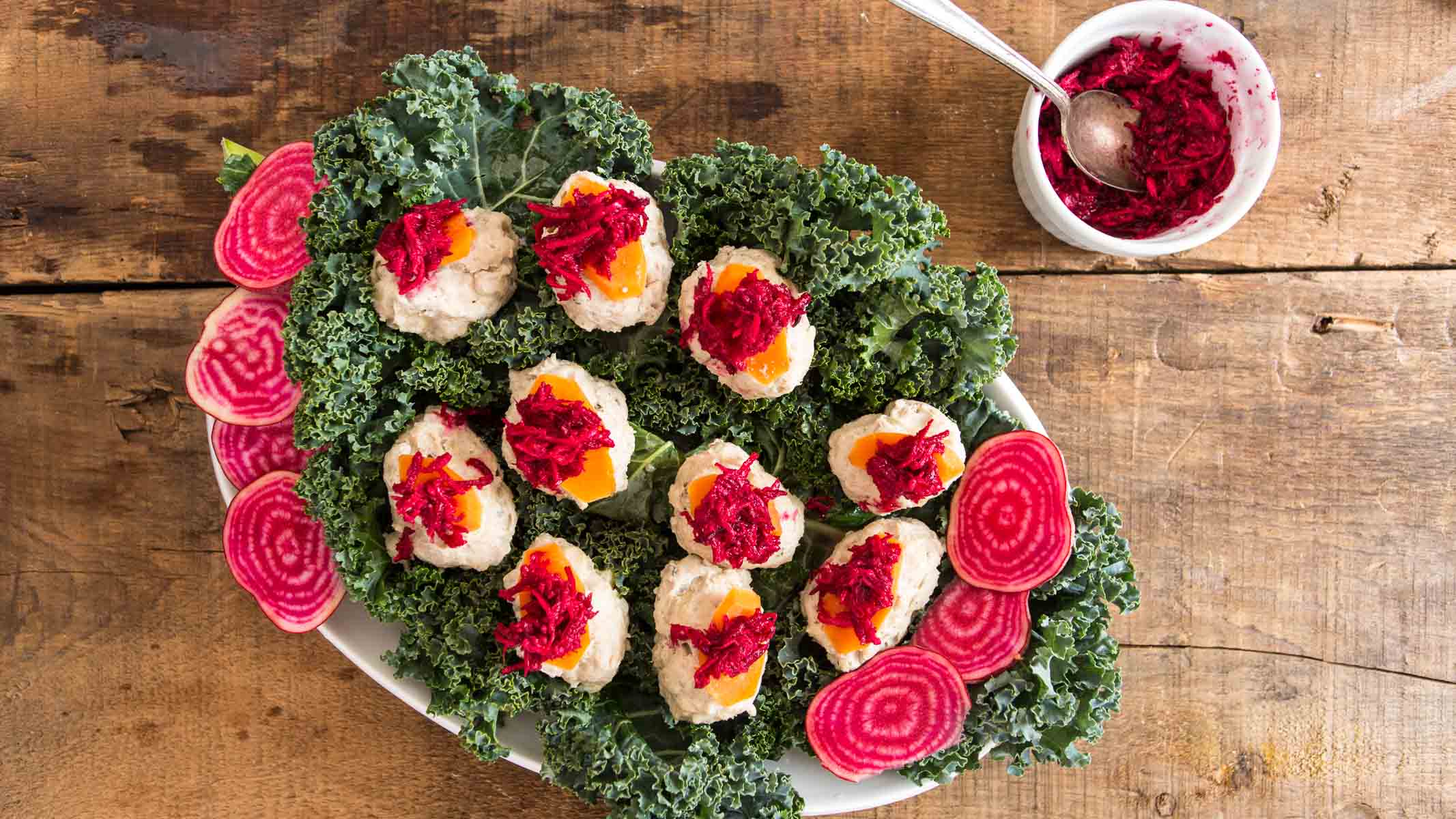 cooked gefilte fish with beetroot horseradish and carrot slices