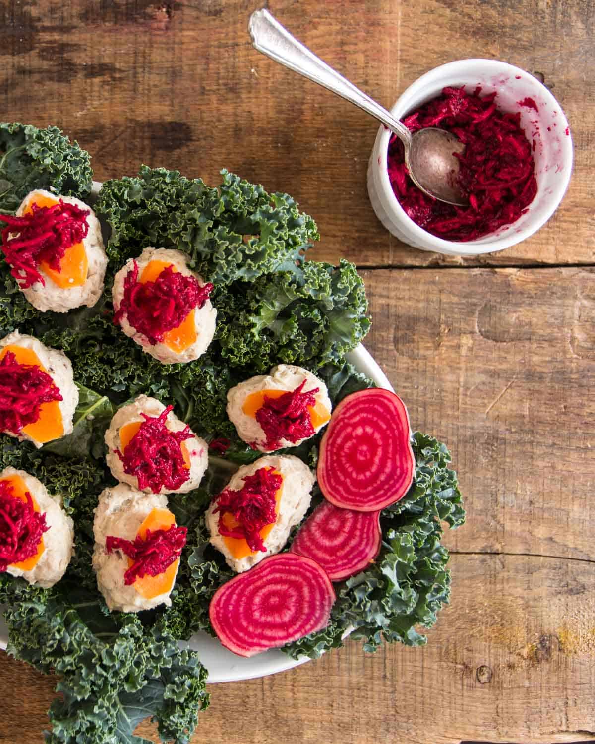 cooked gefilte fish with beetroot horseradish and carrot slices