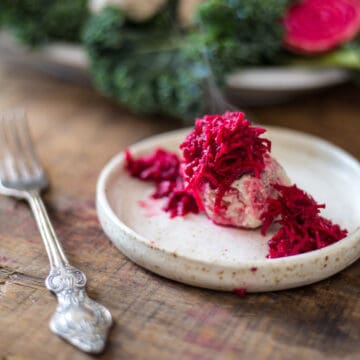 close up on gefilte fish with beetroot on plate