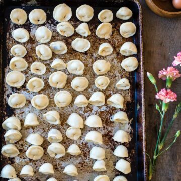 A baking sheet with a tray of gnocchi on it.