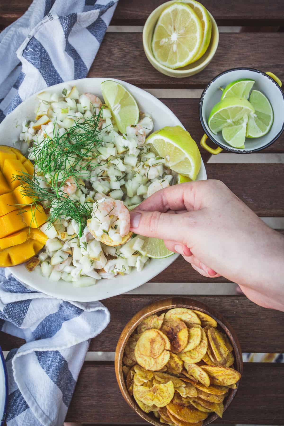 hand scooping out ceviche