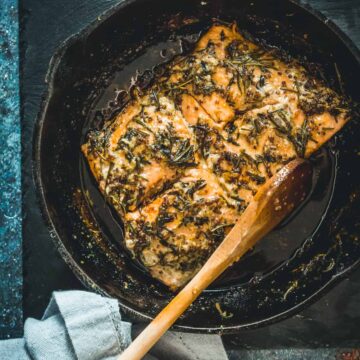 Pan-fried sockeye salmon with sprigs of thyme.