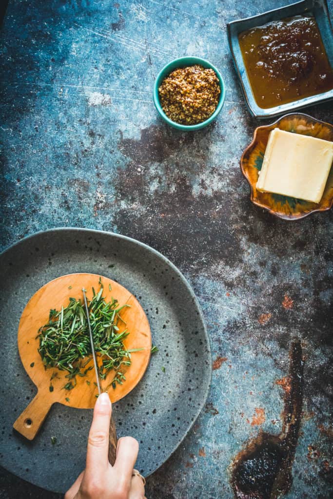 Herbs being cut on cutting board