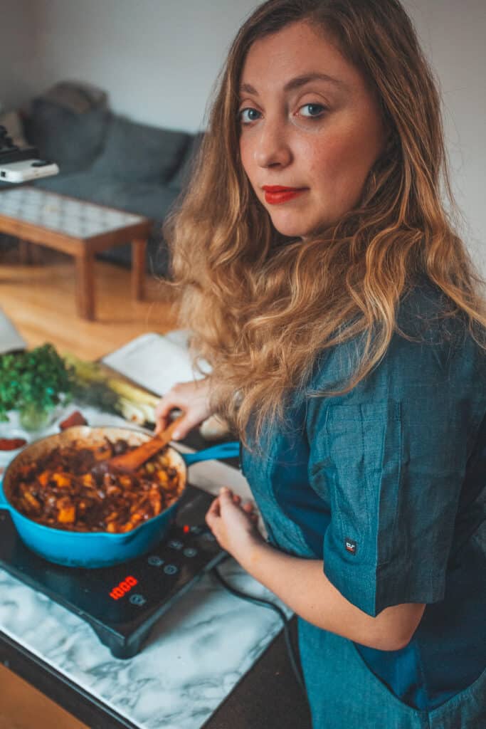 Ksenia cooking in chef coat