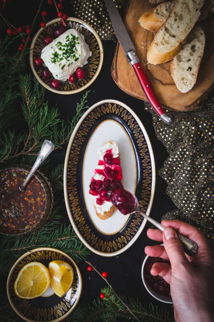 spooning cranberry sauce